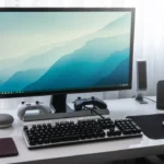 black computer keyboard beside silver imac